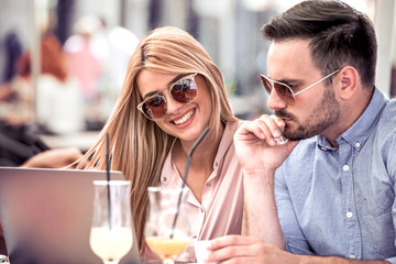 Young couple with laptop in cafe