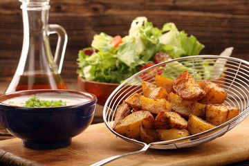 Baked potatoes with herbs and white dip
