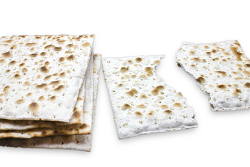 A photo of two pieces of matzah or matza isolated on white background. Matzah for the Jewish Passover holidays. Place for text, copy space. Selective soft focus.
