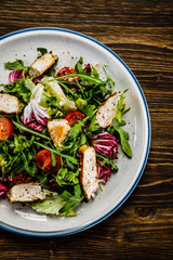 Caesar salad on wooden table 