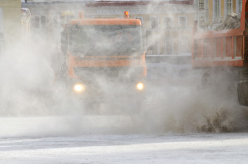 Snow-removal vehicles on the streets.