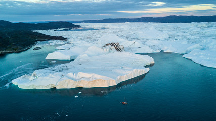 Yacht and largest icebergs field. Classic Greenland drone view © mikhail79spb