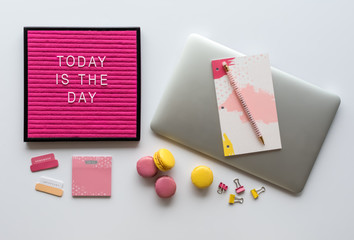 Agenda, Laptop Computer, Colorful Office Accessories and Motivational Letter Board Quote on White Desk Top