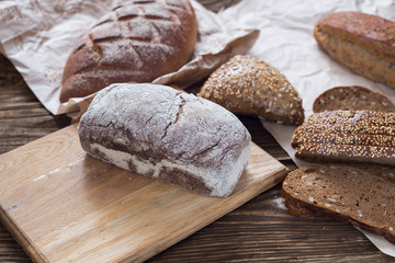 Different bread on table close-up. healthy bread on wooden background, craft paper.