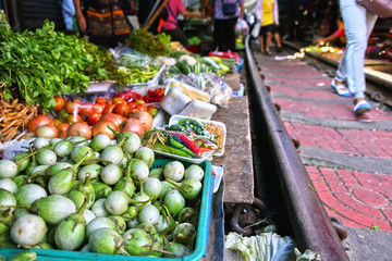 Selling food on the Maeklong Railway market in Thailand
