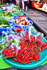 Selling food on the Maeklong Railway market in Thailand