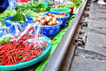 Selling food on the Maeklong Railway market in Thailand
