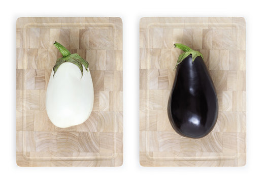 white and black eggplants on wooden cutting board food top view isolated on white