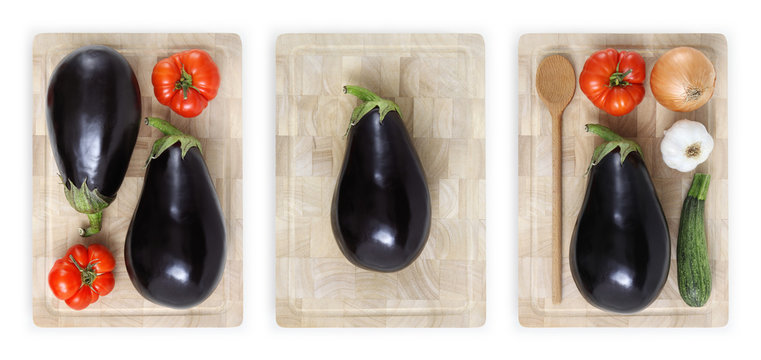 eggplants, tomatoes, zucchini, garlic and onion on wooden cutting board isolated on white banner parmigiana concept