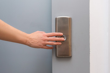 Woman hand pressing lift botton