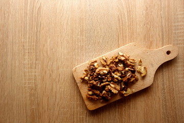 Walnut seeds on wooden background with copy space for your text or object