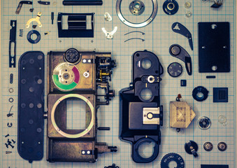 parts old retro film SLR camera on graph paper