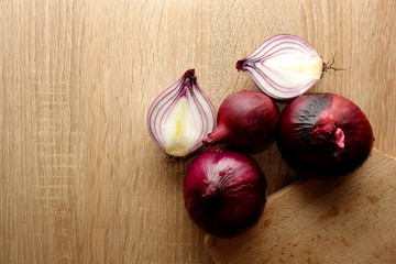 Red onion on wooden background with copy space for your design