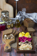 assorted pickled vegetables on wooden background