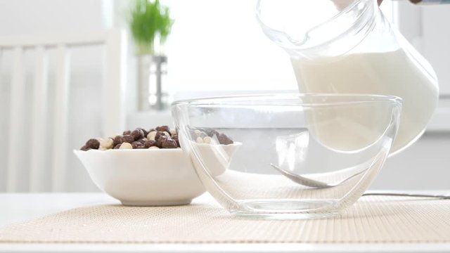 Man Preparing Breakfast in a Bowl Mixing Fresh Milk and Cereals with Chocolate