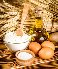 Assortment of baked bread on wooden table background