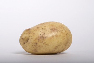 Raw potato isolated on white background.
