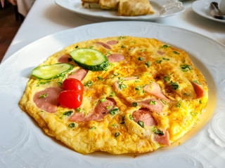 Omelette with bacon, cucumbers and tomatoes