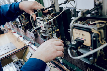 Electrician worker checking electricity meters. Electrical equipment.