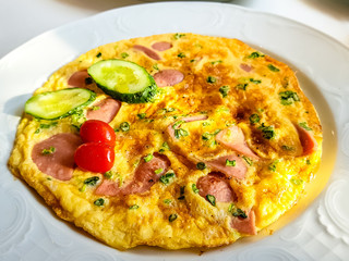 Omelette with bacon, cucumbers and tomatoes