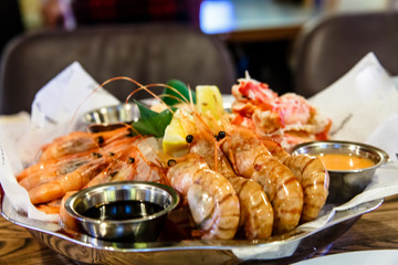 Crabs, shrimp, langoustines, scallops lay on a large platter.