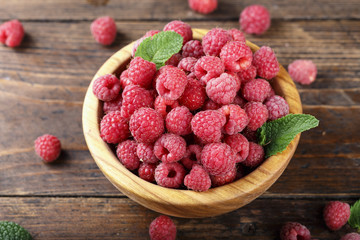 Fresh raspberry in a wooden plate