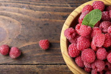 Fresh raspberry in a wooden plate