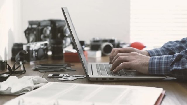 Professional photographer connecting with a laptop