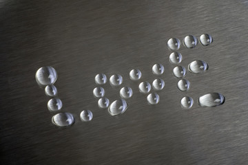 Drops in the form of words like. The surface is metallic