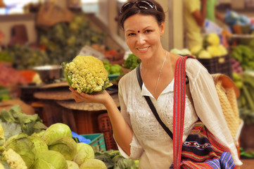 woman choosing vegetables on market