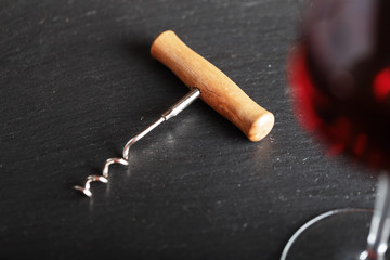 corkscrew next to a glass
