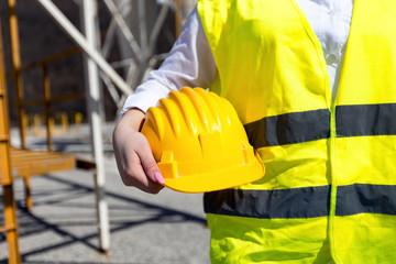 close up shot of construction worker holding helmet