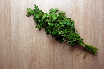 Bunch of green parsley leaves on rustic wooden background, copy space for your design