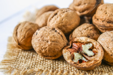 Shells and bones of walnut on a white wooden table.