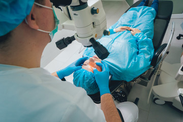 Eye surgery. A patient and surgeon in the operating room during ophthalmic surgery. Vision...