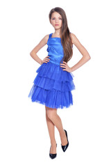 Happy little girl in blue dress posing  isolated