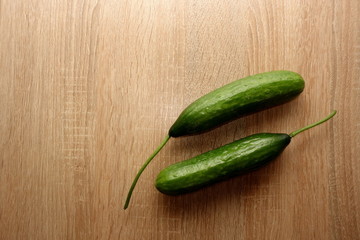 Fresh cucumbers on wooden background, copy space for your design