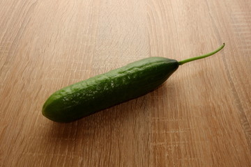 Fresh cucumber on wooden table, copy space for design