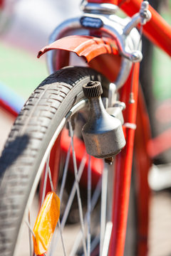 Close-up of a Bicycle Dynamo on a red Retro Bike, View from the Front