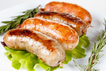 Roast beef or chicken sausage on a plate