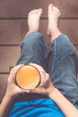 one boy is sitting with a glass of juice © altanaka