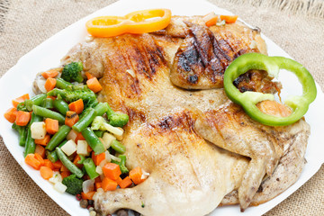 Chicken fried with vegetables on a napkin of burlap