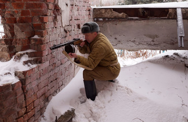 Fighter of Red army with the machine gun in ruins of Stalingrad