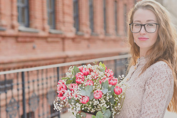 Girl with a big bouquet of tulips