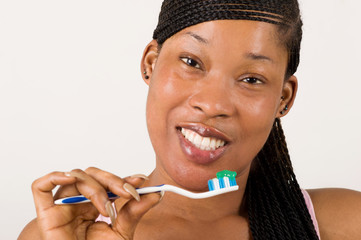 close up young woman brushing teeth happily isolated on light background