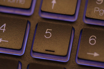 Closeup of laptop keyboard illumination, backlit keyboard