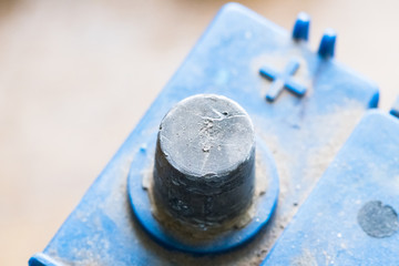 Terminals of the old dirty battery. Charging car battery with electric current.