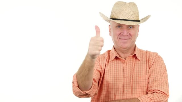 Pleased and Smiling Farmer Looking to Camera Thumbs Up an Pointing with Finger