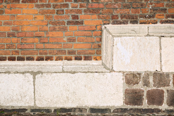 Weathered church wall with different types of bricks
