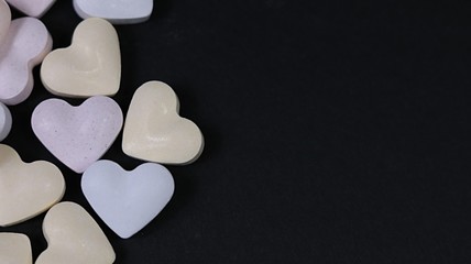 Heart candy on black background with copy space